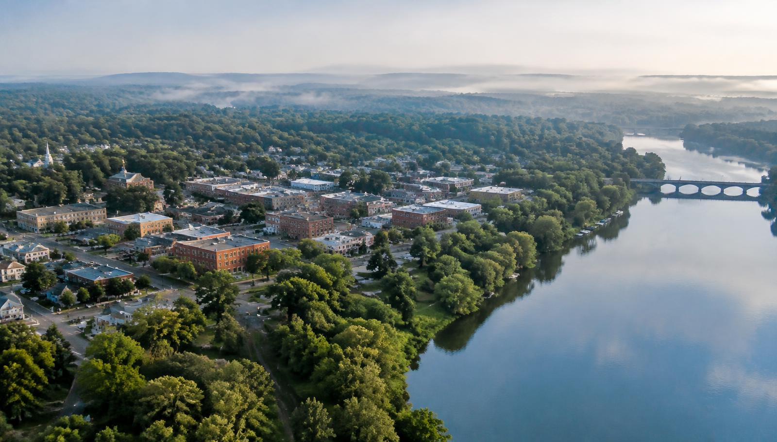 Illustrative photo: aerial view of a riverside Piedmont town at morning