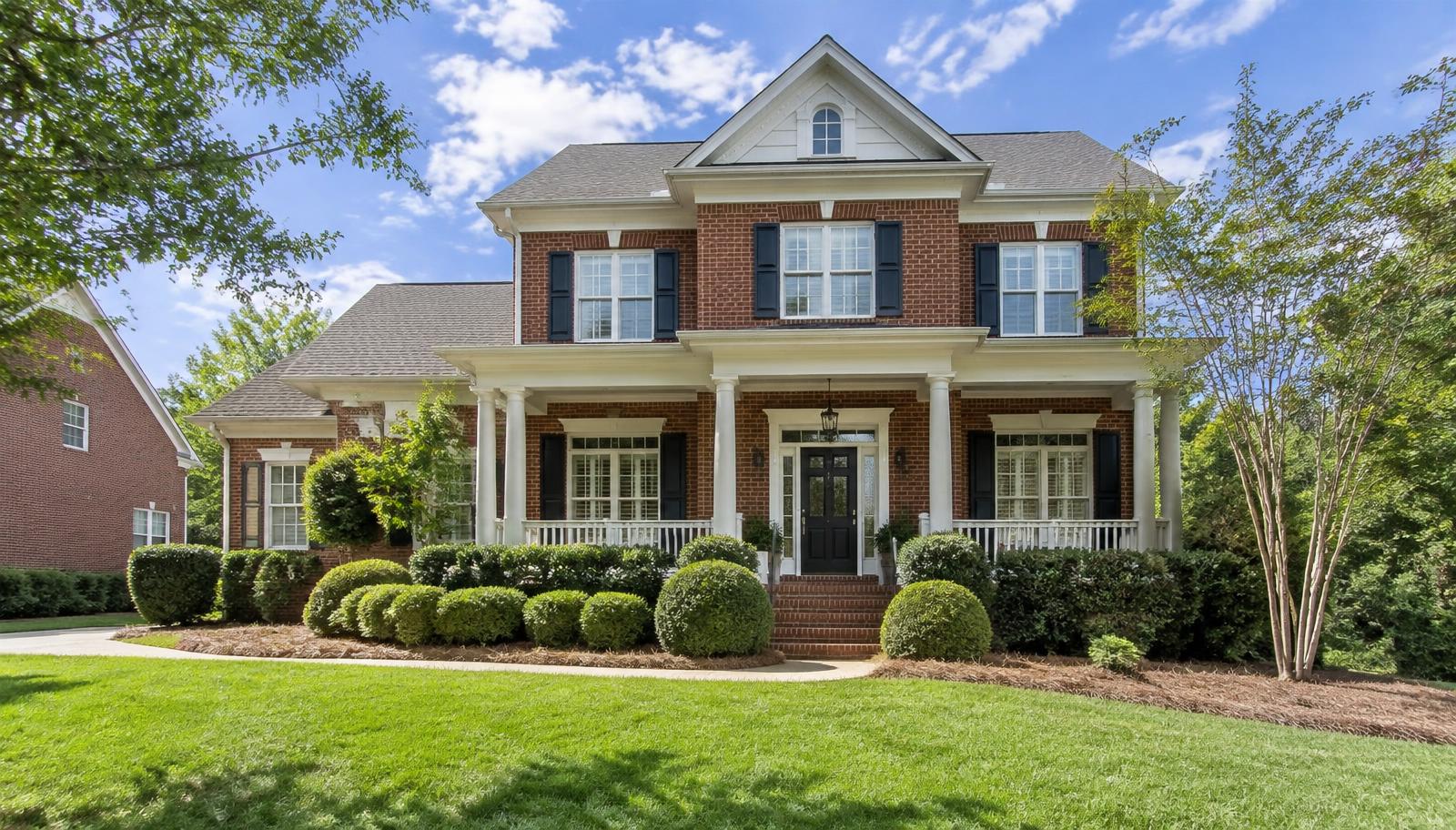 Illustrative photo: a brick two-story home with a front porch