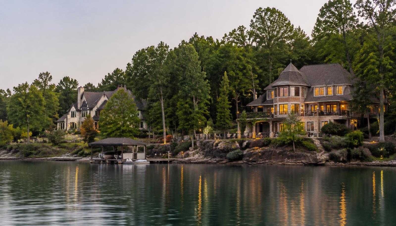 Illustrative photo: lakeside homes among hardwoods at dusk